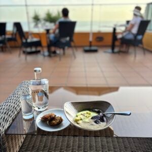 Ayurvedic breakfast with warm porridge by the ocean